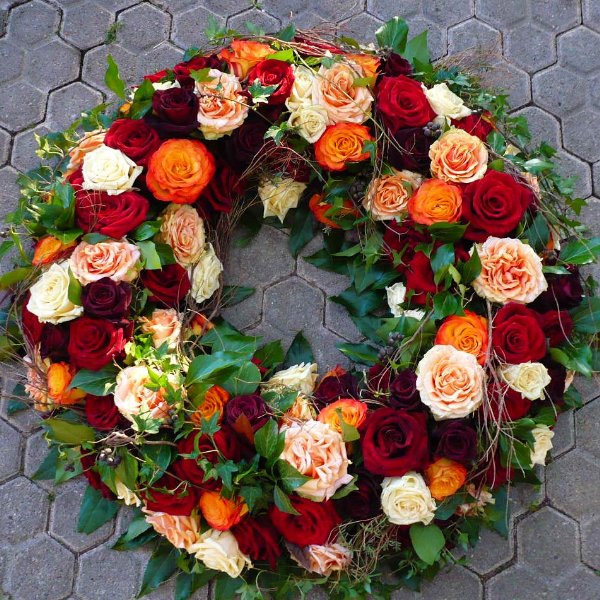 Trauerkranz mit roten und orangenen Rosen Bild 1